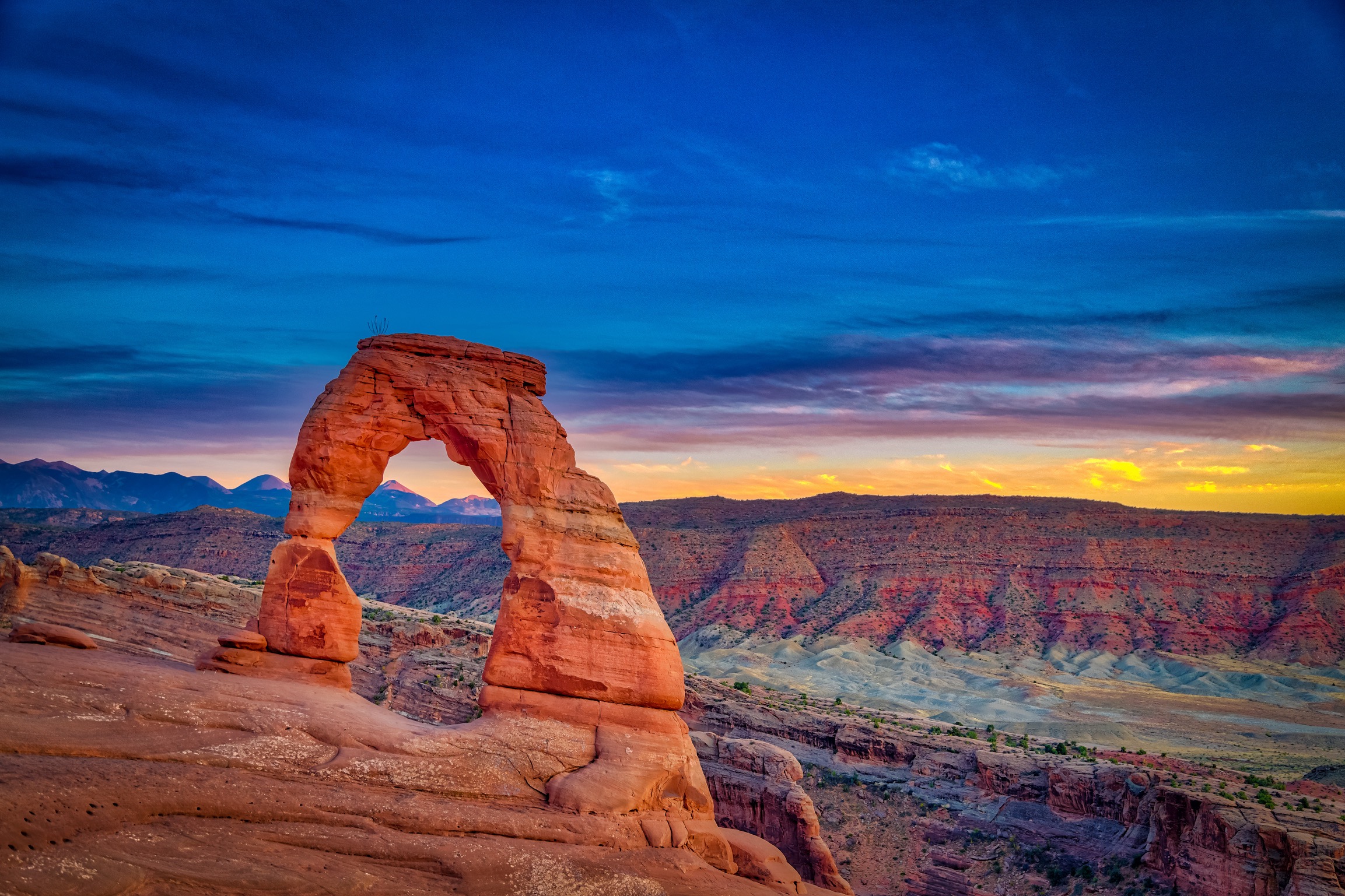 Arches Park Utah. Delicate Arch in the background showcasing Landskein art of the horizon. Arches Park Utah. Delicate Arch in the background showcasing Landskein art of the horizon.