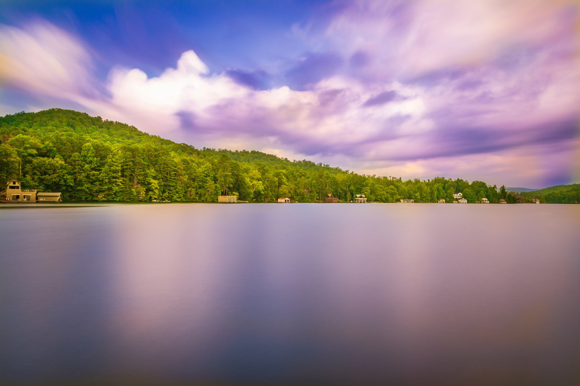 Long exposure photography using ND filter showing movement of clouds and causing blurring of lake surface producing mirror like effect.Lake Burton, GA. Long exposure photography using ND filter showing movement of clouds and causing blurring of lake surface producing mirror like effect.Lake Burton, GA.