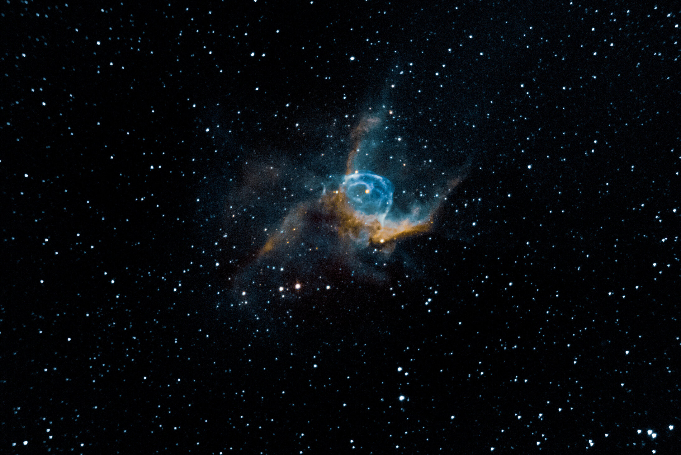 Thor’s Helmet is an emission nebula in the constellation Canis Major. The name of this nebula stems from its striking resemblance to the helmet of the famed Norse God of thunder and lightning. The nebula is approximately 3,670 parsecs (11.96 thousand light years) away and 30 light-years in size. The central star is the Wolf-Rayet star WR7, an extremely hot star thought to be in a brief pre-supernova stage of evolution.